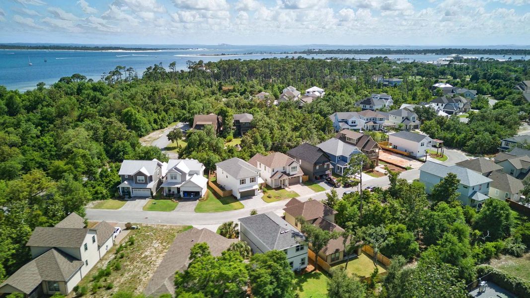Aerial view of the Sanctuary Beach community in Panama City Beach, FL, showing layout and nearby surroundings (Image 1).