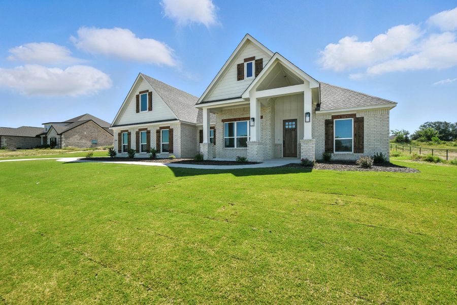 Front exterior of a home in the Whispering Winds community, located in Springtown, TX (Image 2).