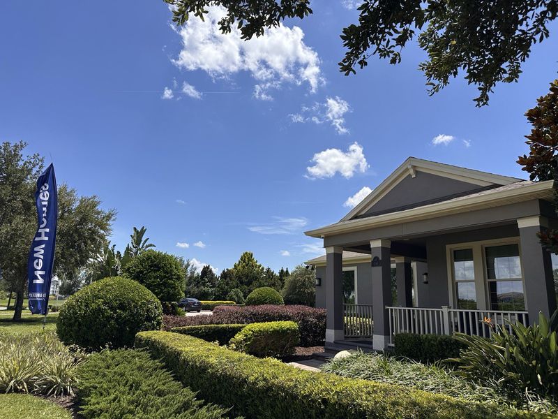 A charming gray home with lush landscaping in Waterleigh by D.R. Horton (Winter Garden, FL).