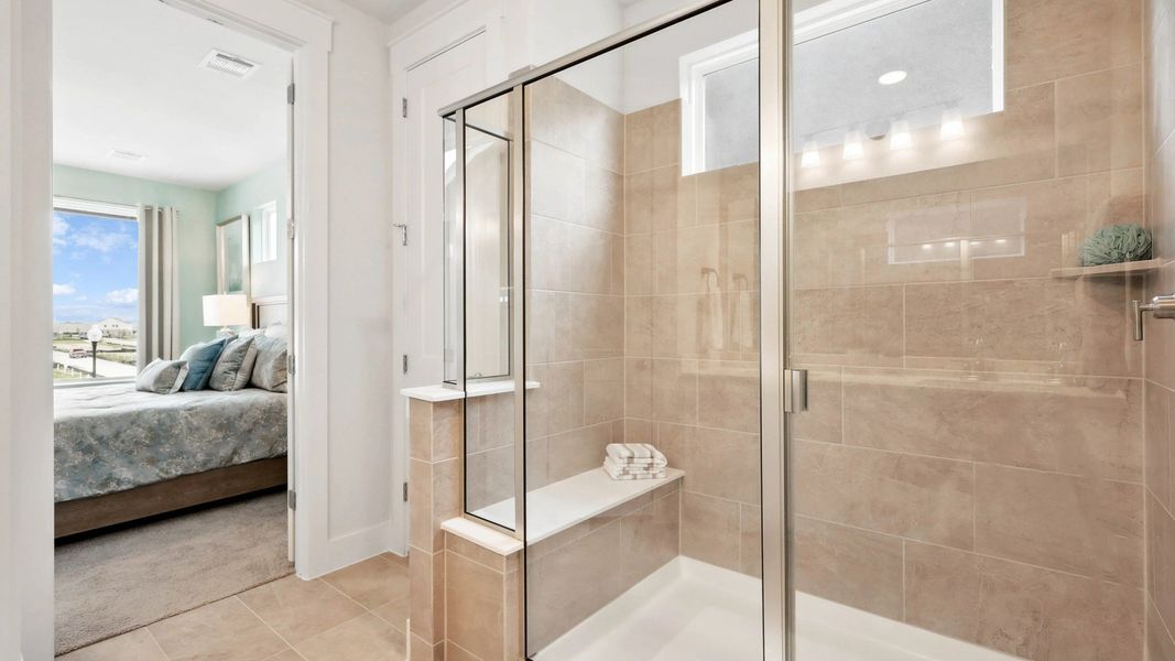 Experience chic design with a glass-enclosed shower and premium beige tiles in Collin Creek's exquisite homes. Experience chic design with a glass-enclosed shower and premium beige tiles in Collin Creek's exquisite homes.