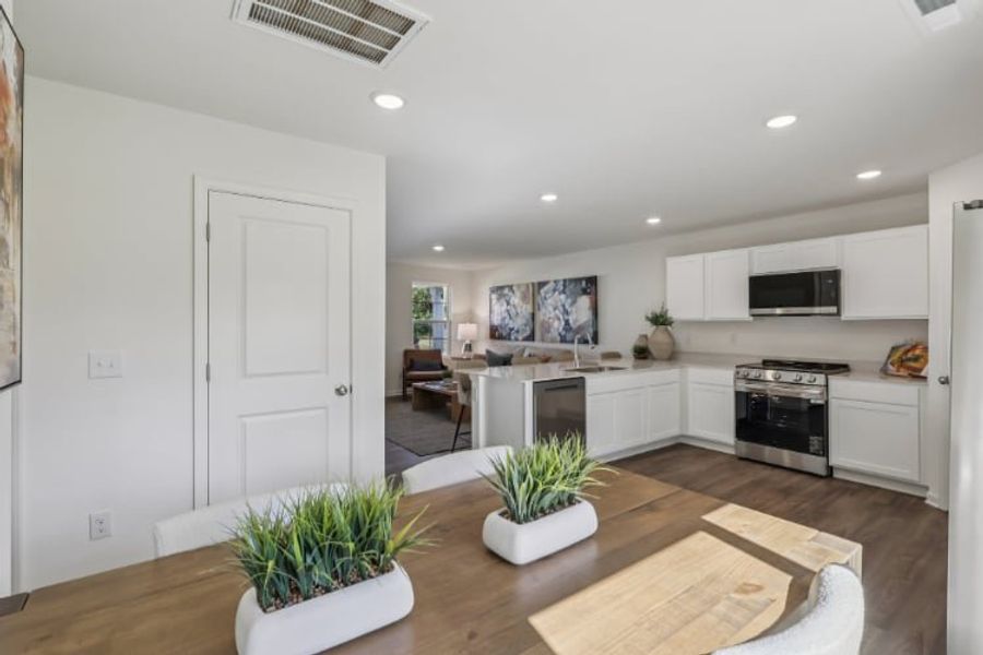 A kitchen with white cabinets.