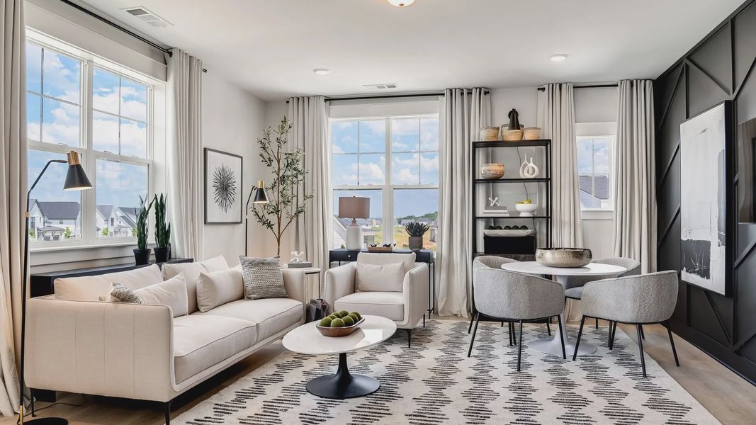 Experience refined design with spacious windows, abstract art, and a chic patterned rug in Tennessee's Shelton Square.