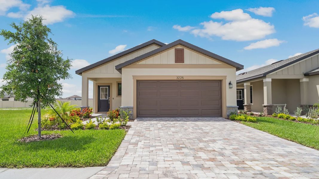 Front exterior of a home in the Grasslands West community, located in Lakeland, FL (Image 13).
