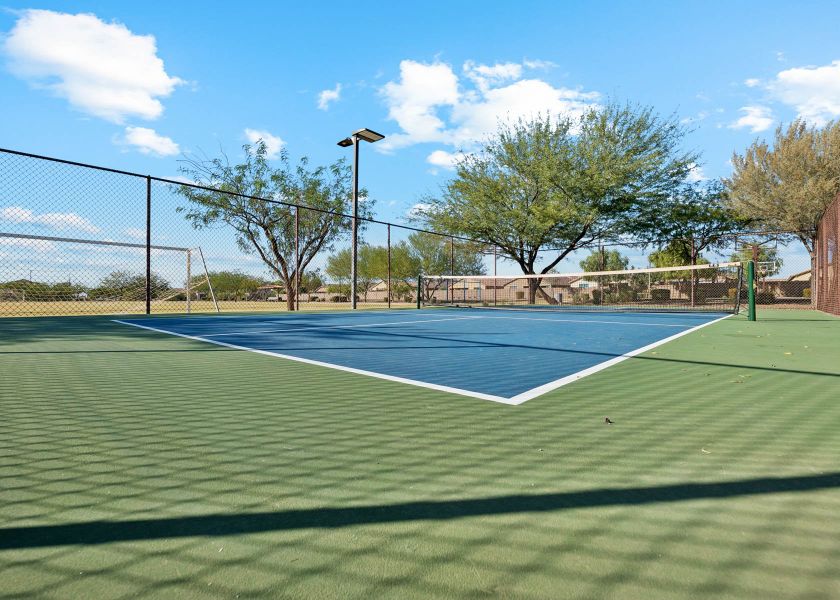 A tennis court with a fence. A tennis court with a fence.