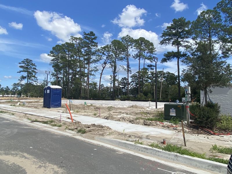 A developing site in Egret Creek by Mattamy Homes, Jacksonville, FL, surrounded by tall trees and open sky.