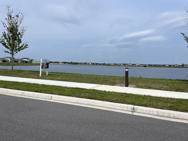 Scenic waterfront view in The Peninsula at Rhodine Lake by David Weekley Homes, Riverview, FL, with expansive lake vistas.