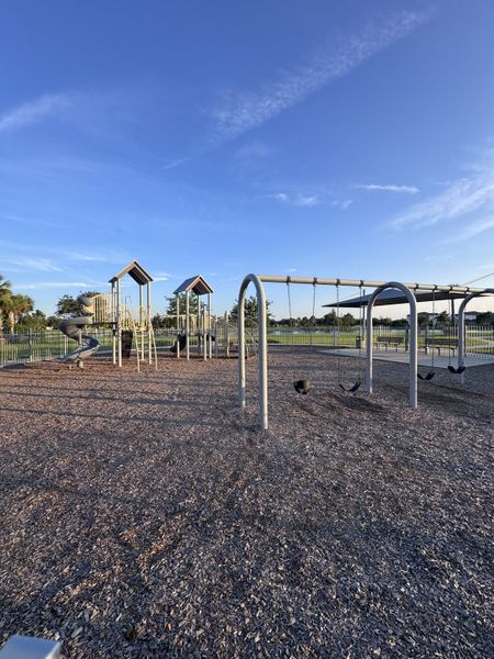 A scenic playground with swings and slides at The Preserve at Bannon Lakes by Pulte Homes in St. Augustine, FL.