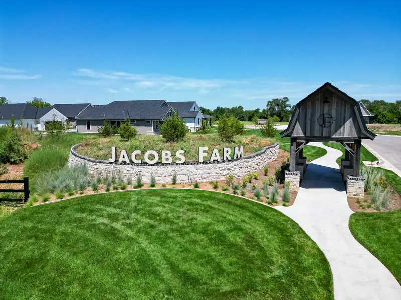 Entrance to the The Courtyards at Jacobs Farm community in Wichita, KS, featuring signage and landscaping (Image 2). Entrance to the The Courtyards at Jacobs Farm community in Wichita, KS, featuring signage and landscaping (Image 2).