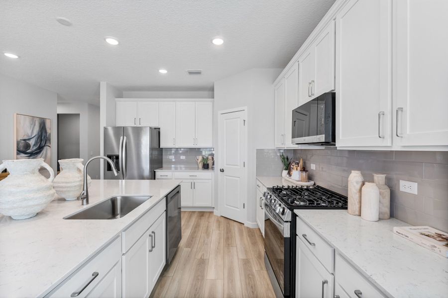 Coronado Model Home Kitchen with Walk-In Corner Pantry at Reserve East