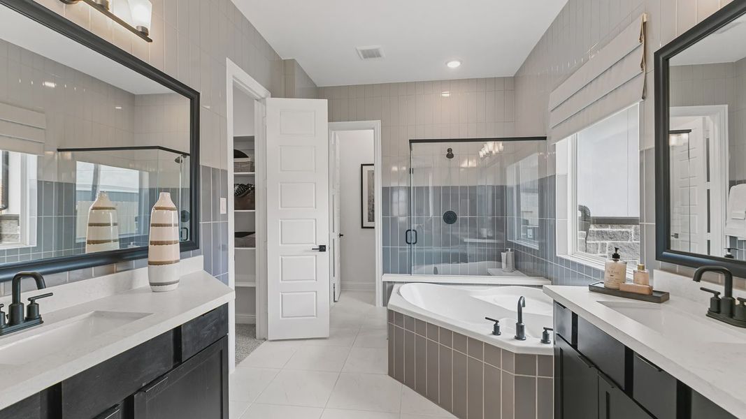 Experience opulence with dual vanities, a soaking tub, and exquisite tiling in Beamer Villas’ luxurious bathroom. Experience opulence with dual vanities, a soaking tub, and exquisite tiling in Beamer Villas’ luxurious bathroom.