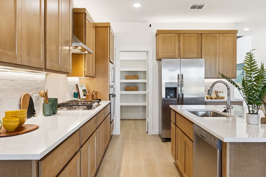 REPRESENTATIVE PHOTO – Kitchen in the Winters model home in Aledo TX by Trophy Signature Homes