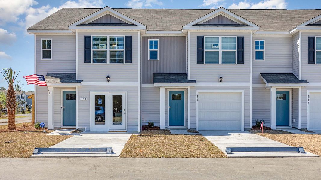 Front exterior of a home in the The Cove at Glenns Bay community, located in Surfside Beach, SC (Image 1).