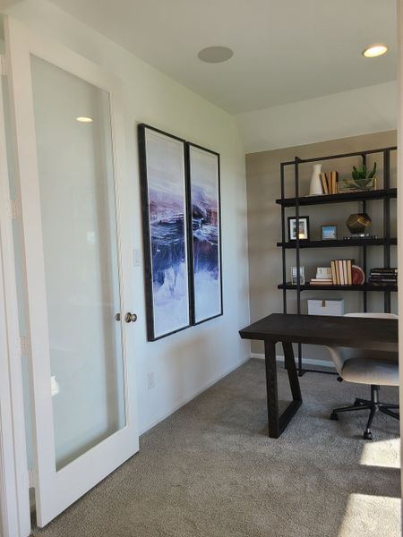 A sleek home office with a modern desk, elegant shelving, and abstract art, offering a bright and productive workspace. A sleek home office with a modern desk, elegant shelving, and abstract art, offering a bright and productive workspace.