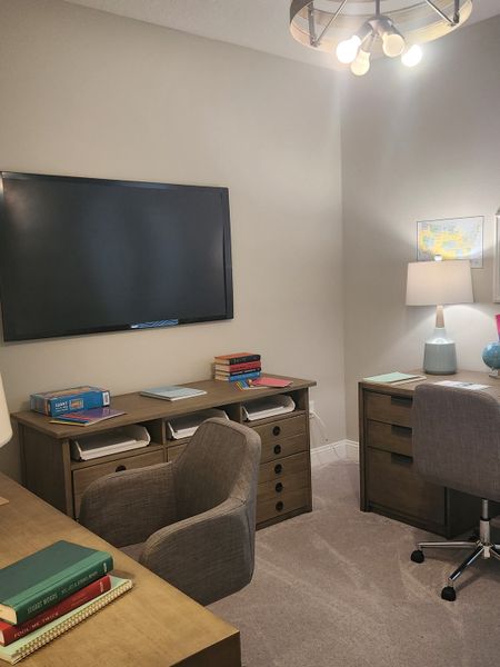 A cozy home office with modern desks, neutral decor, and ample lighting, perfect for productivity and comfort. A cozy home office with modern desks, neutral decor, and ample lighting, perfect for productivity and comfort.