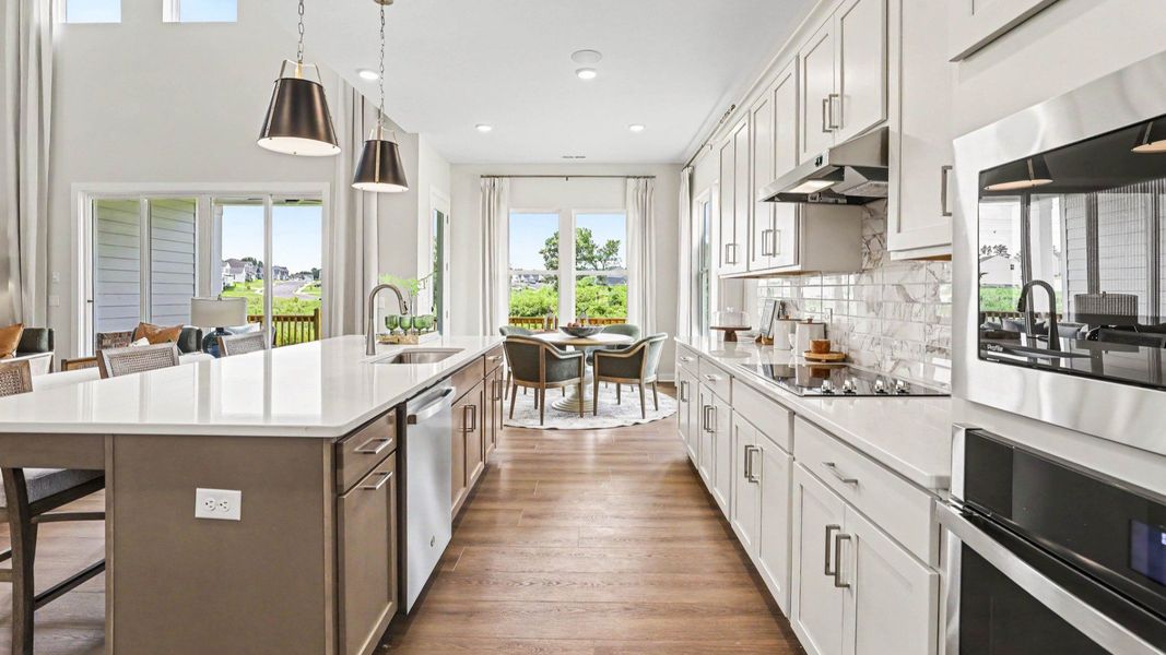 Kitchen with quartz countertops, tile backsplash, and light cabinetry Kitchen with quartz countertops, tile backsplash, and light cabinetry