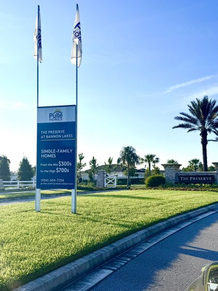 A serene entrance with lush landscaping in The Preserve at Bannon Lakes by Pulte Homes (St. Augustine, FL).