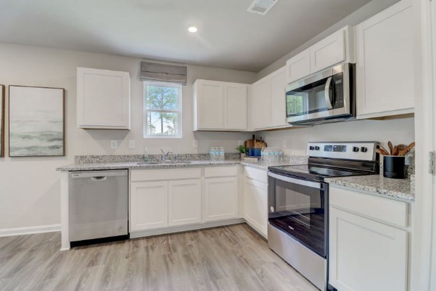 A kitchen with white cabinets. A kitchen with white cabinets.