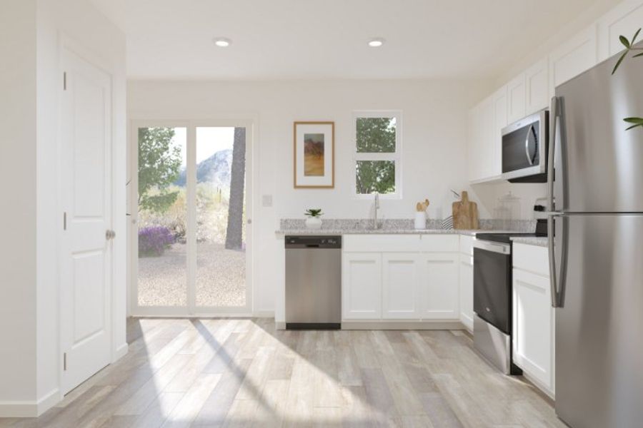 A kitchen with white cabinets.
