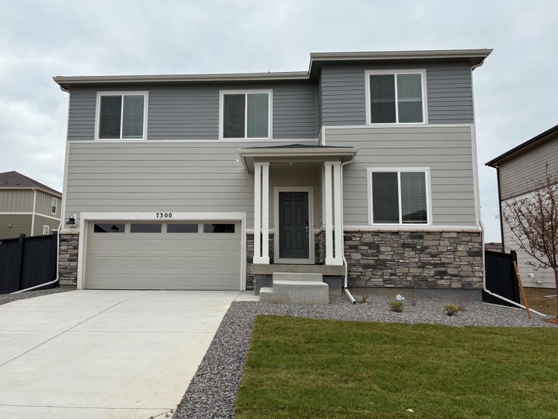Front exterior of a home in the Frontier Estates - The Flora Collection community, located in Firestone, CO (Image 8).