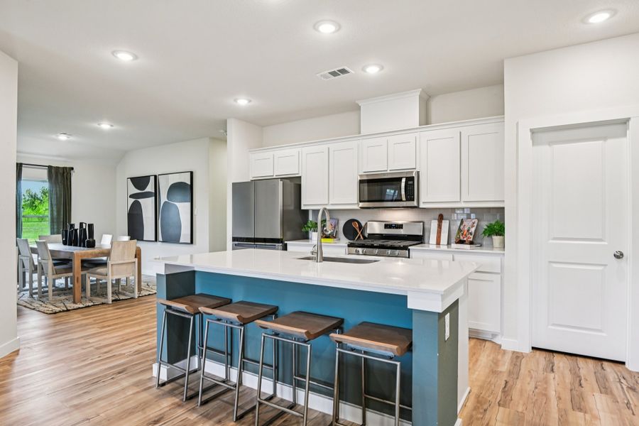 A kitchen with white cabinets.
