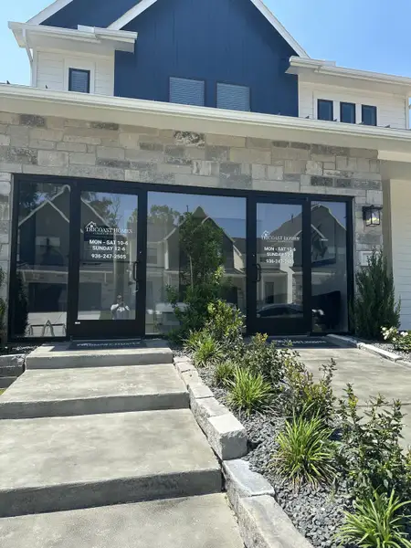 A modern stone exterior with sleek windows in Summer Place 35' by Tricoast Homes (Montgomery, TX).