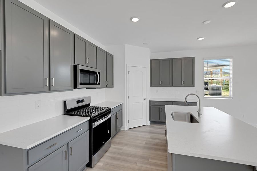 A kitchen with white cabinets. A kitchen with white cabinets.