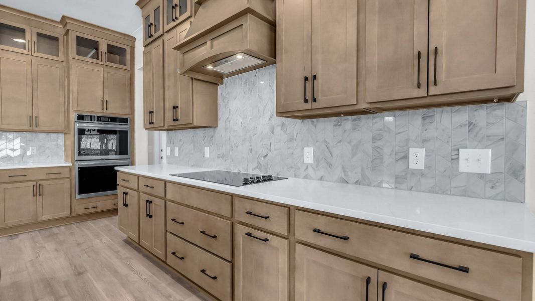 Gorgeous kitchen finishes with tile backsplash, upgraded cabinets, and quartz countertops Gorgeous kitchen finishes with tile backsplash, upgraded cabinets, and quartz countertops