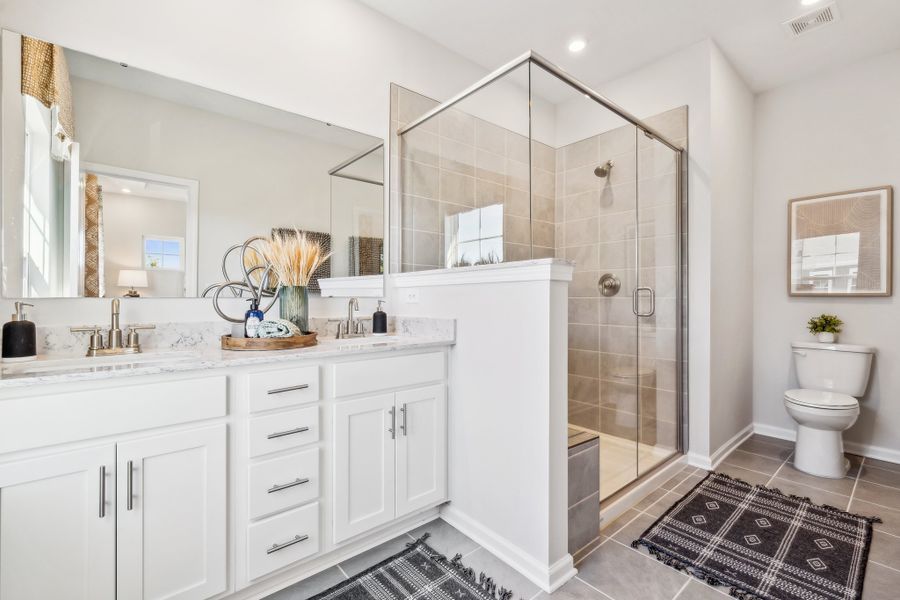 A bathroom with a glass shower. A bathroom with a glass shower.