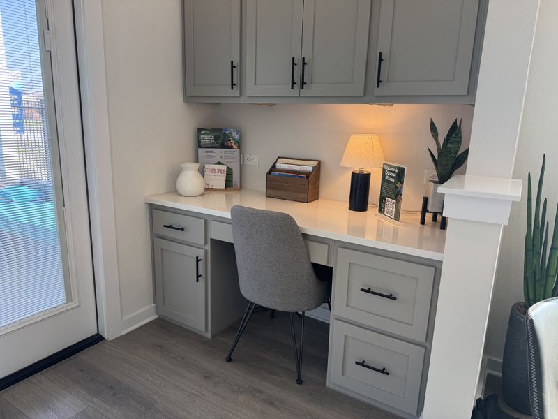 A cozy study nook featuring gray cabinets, a sleek desk, and modern decor, perfect for productivity. A cozy study nook featuring gray cabinets, a sleek desk, and modern decor, perfect for productivity.