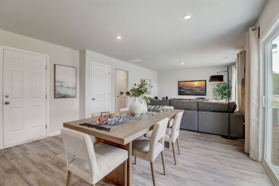 A dining room with a couch and chairs. A dining room with a couch and chairs.