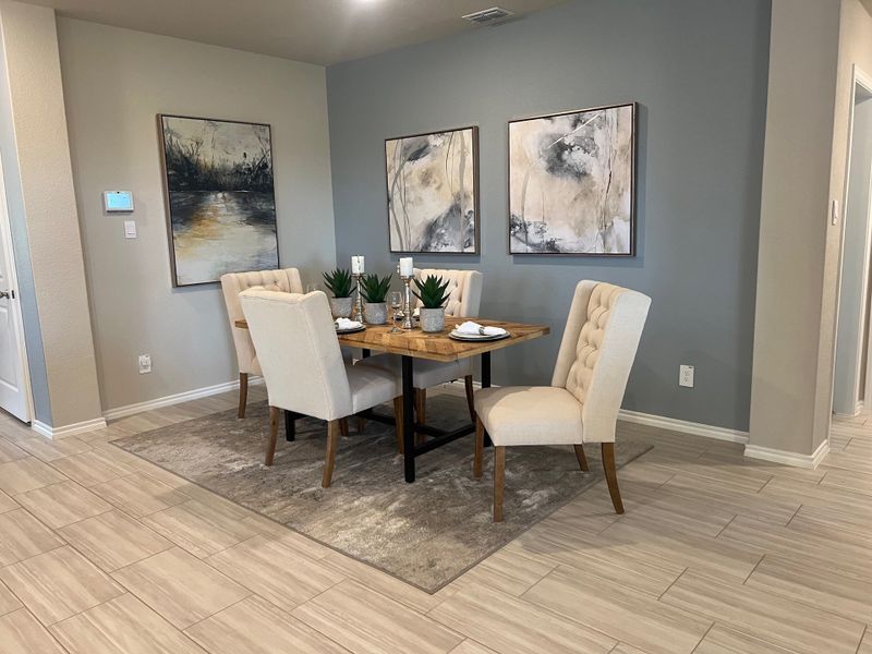 A cozy dining room features a wooden table, plush chairs, and abstract art, creating a modern and inviting space. A cozy dining room features a wooden table, plush chairs, and abstract art, creating a modern and inviting space.