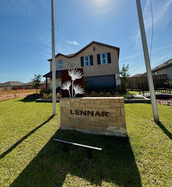 A beautiful brick home with dark shutters and landscaped lawn in The Grand Prairie: Watermill Collection by Lennar (Hockley, TX).