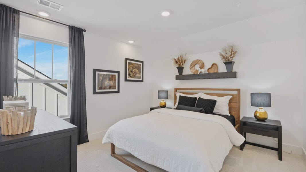 Modern secondary bedroom with elevated ceilings and cozy carpet at Pleasant Falls by DRB Homes in Moore, SC