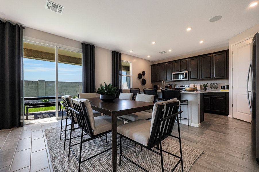A kitchen with a dining table. A kitchen with a dining table.