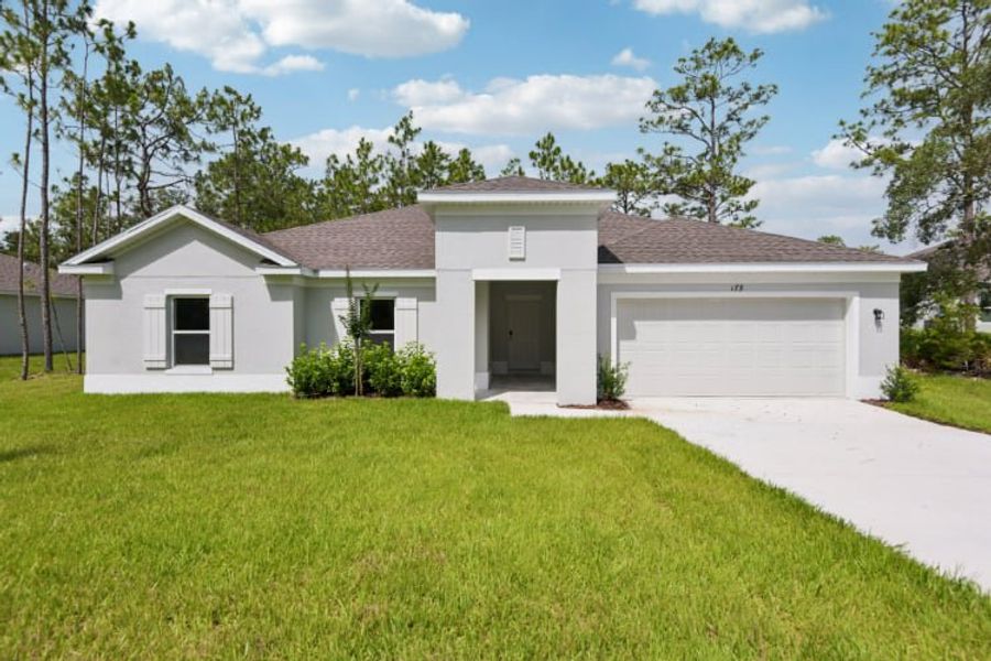 A white house with a driveway.