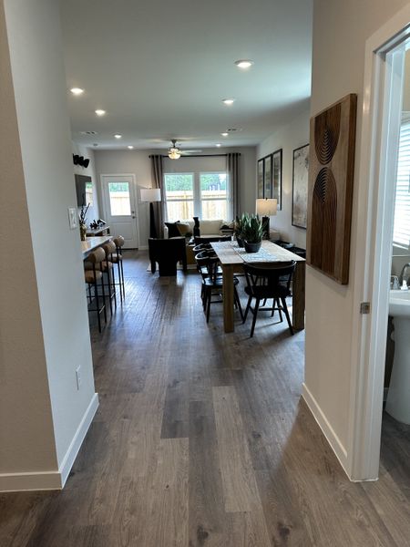 An open-concept living area with sleek wood floors, modern decor, and ample natural light.