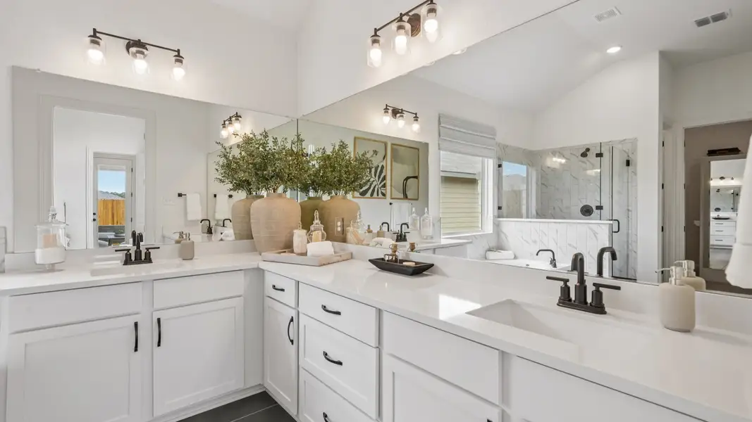 Spacious owner’s bath vanity with dual sinks, modern black fixtures, and clean modern design Spacious owner’s bath vanity with dual sinks, modern black fixtures, and clean modern design