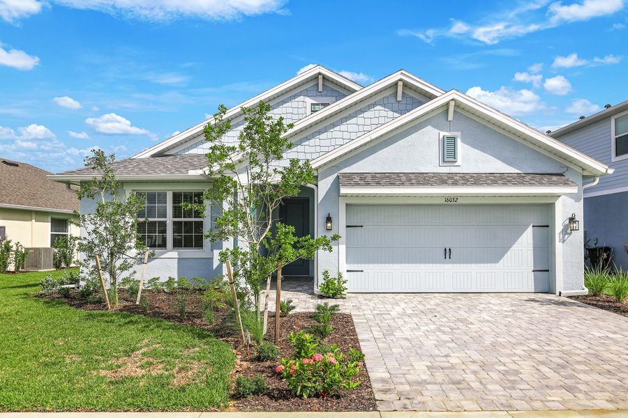 Front exterior of a home in the The Sanctuary – Resort Collection community, located in Punta Gorda, FL (Image 6).