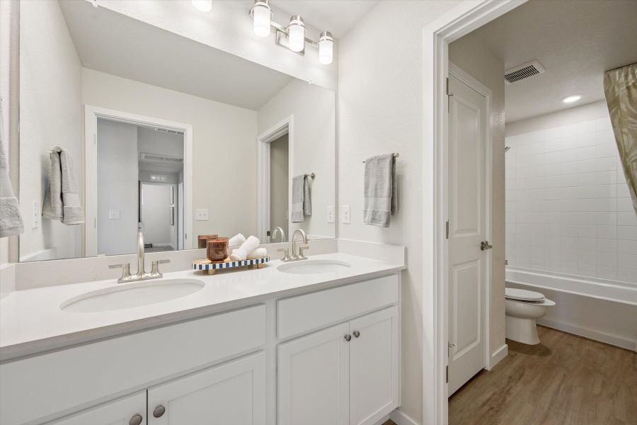 A bathroom with a large mirror. A bathroom with a large mirror.