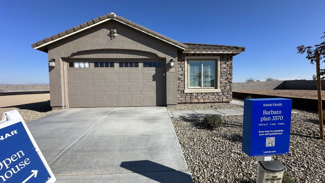 Front exterior of a home in the Asante: Discovery 2.1 & 2.13 community, located in Surprise, AZ (Image 14).