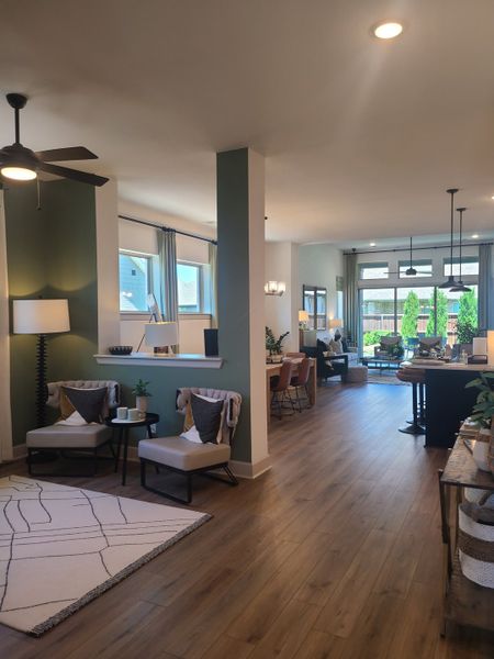 An open-concept living area with hardwood floors, modern decor, and abundant natural light.