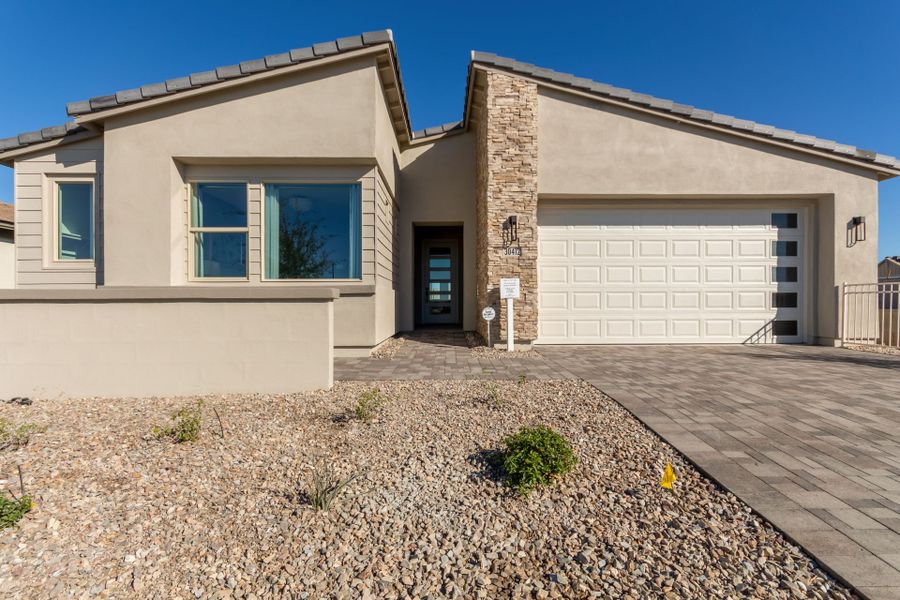 Front exterior of a home in the Agave Springs at Teravalis community, located in Buckeye, AZ (Image 13).