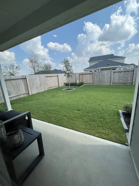 A serene backyard with lush grass and a cozy patio, perfect for relaxation and outdoor enjoyment. A serene backyard with lush grass and a cozy patio, perfect for relaxation and outdoor enjoyment.