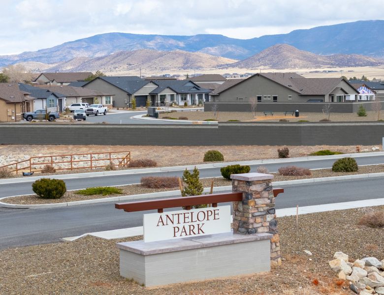 A sign in front of a road.