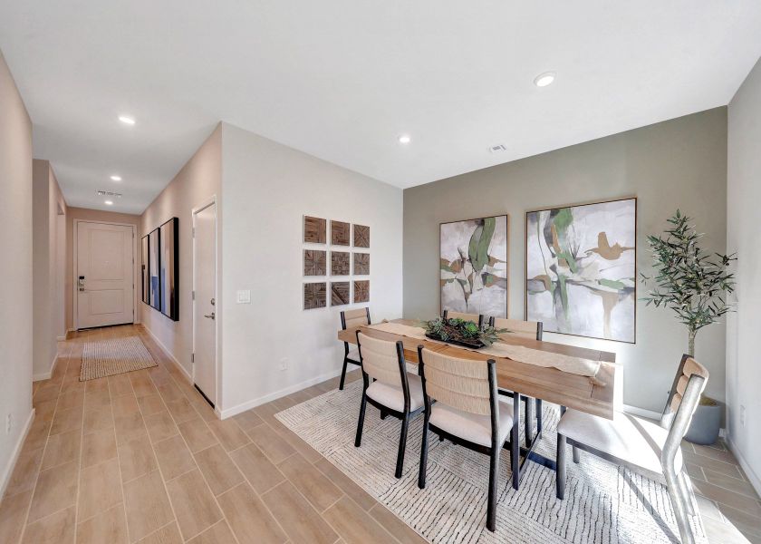 A dining room with a table and chairs.