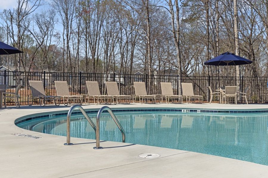 A pool with chairs around it. A pool with chairs around it.