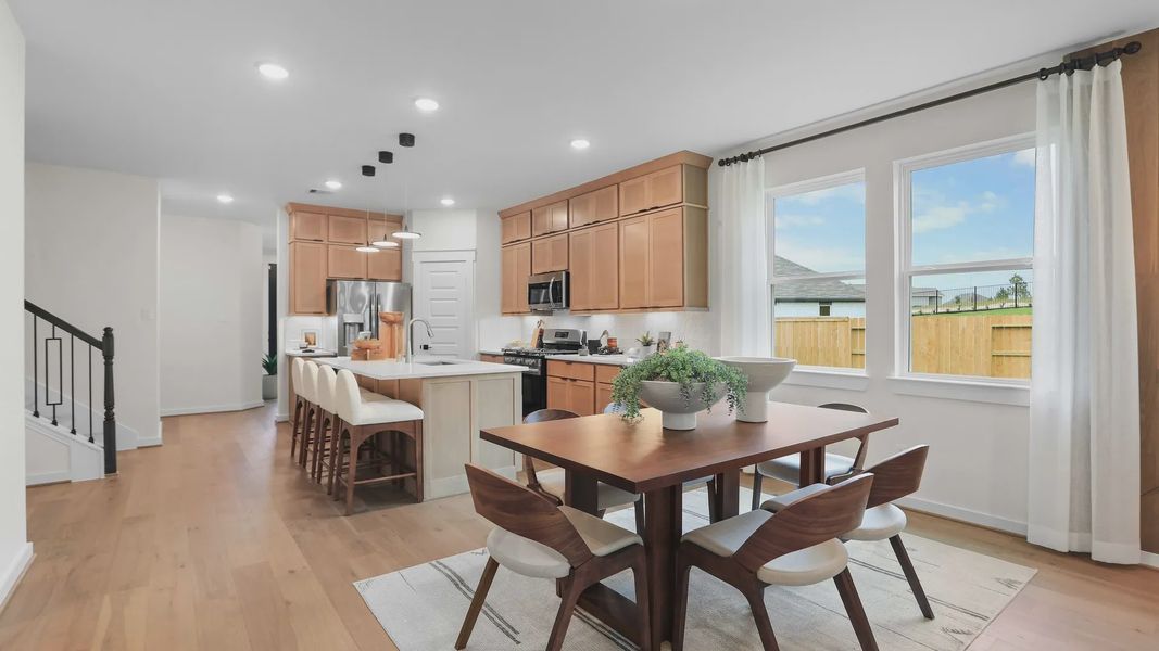 Enjoy sleek wood cabinetry and natural light in this Mostyn Springs kitchen, embodying refined modern living. Enjoy sleek wood cabinetry and natural light in this Mostyn Springs kitchen, embodying refined modern living.
