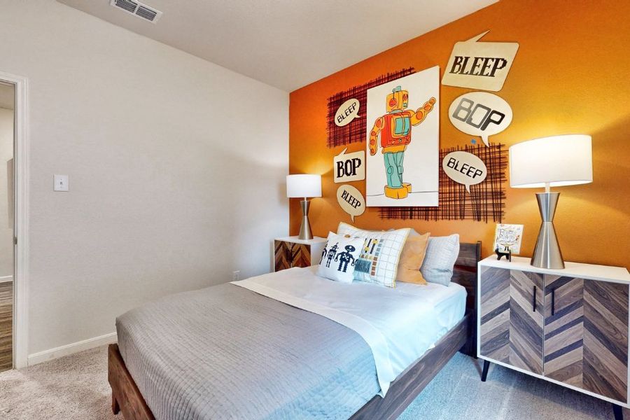 A bed with a blue comforter. A bed with a blue comforter.