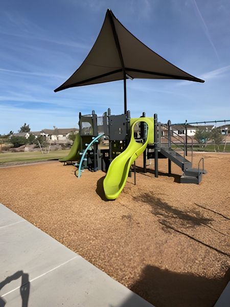 A vibrant playground with slides and shade in Edgewood Estates by K. Hovnanian® Homes (Queen Creek, AZ).