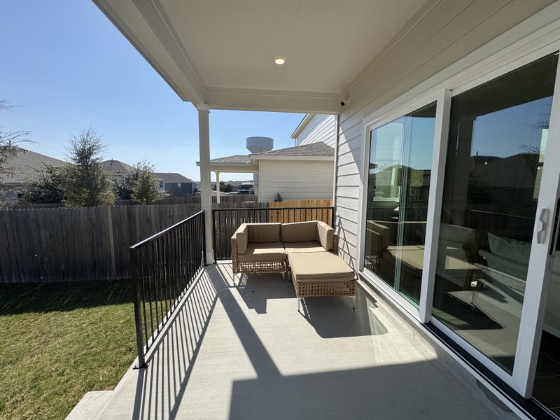 A cozy patio with a wicker sofa set and privacy fence, perfect for relaxation. A cozy patio with a wicker sofa set and privacy fence, perfect for relaxation.